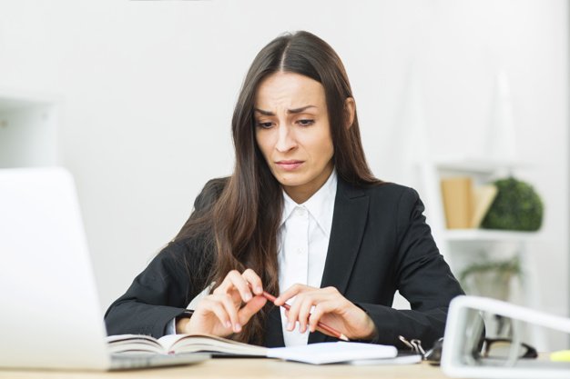 sad young businesswoman holding red pencil her hand sitting office desk 23 2147943708